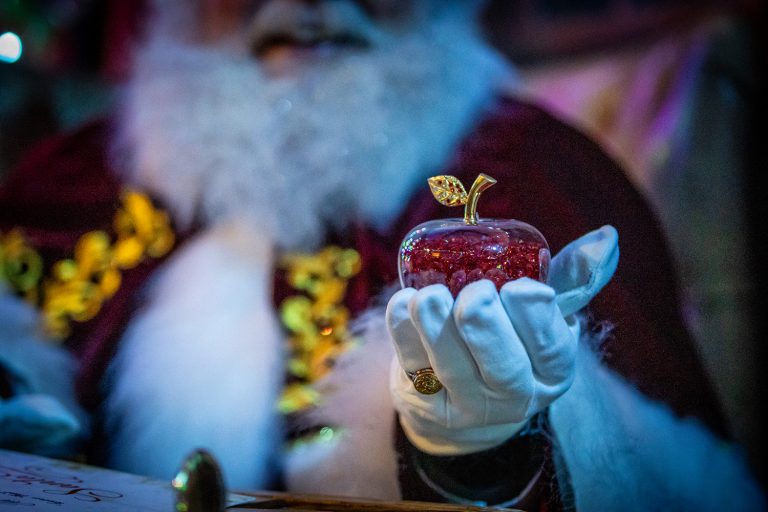 A blurred image of Father Christmas or Santa holding a fairy tale apple